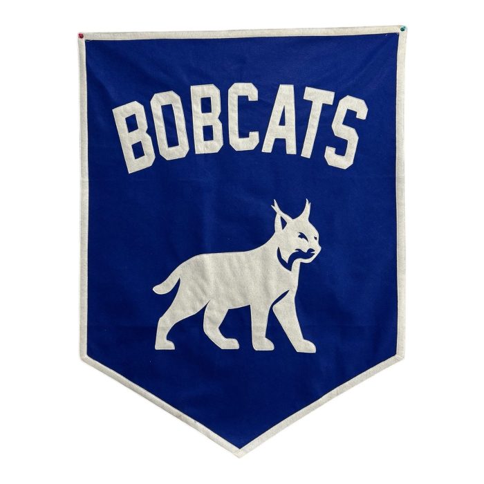 Blue felt Bobcats team banner with a cream felt bobcat