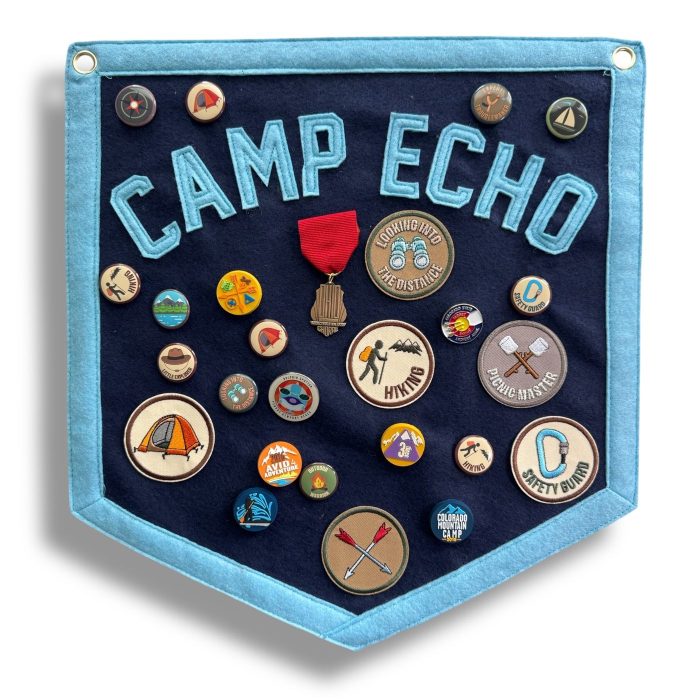 Navy Camp Echo felt pennant covered in activity patches with a red ribbon medal