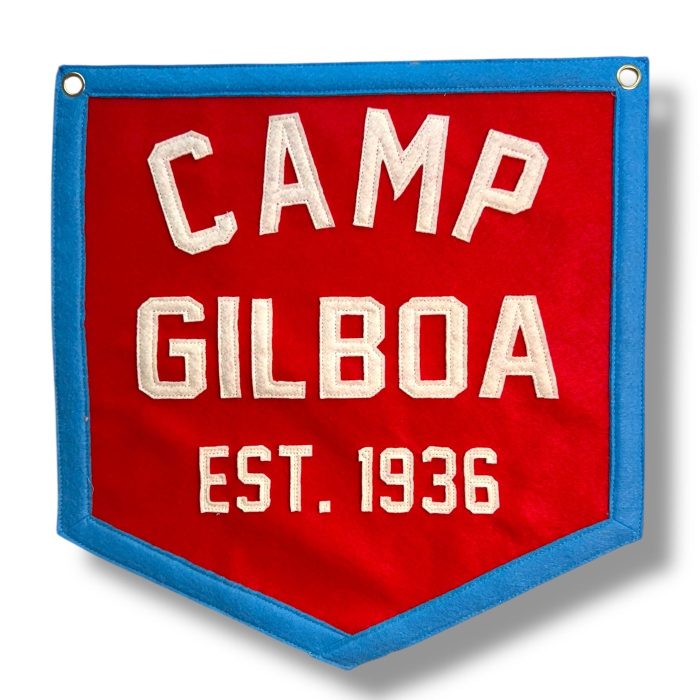 Red felt banner with blue trim reading Camp Gilboa Est. 1936