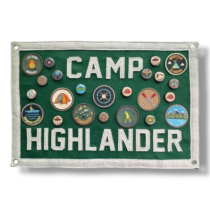 Green Camp Highlander felt banner decorated with round activity patches