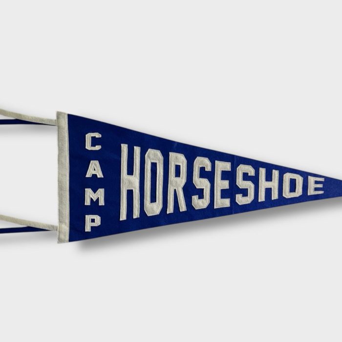 Navy felt Camp Horseshoe pennant with cream lettering and ribbon tails