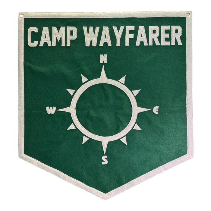 Green Camp Wayfarer felt pennant with a cream compass design ready for patches