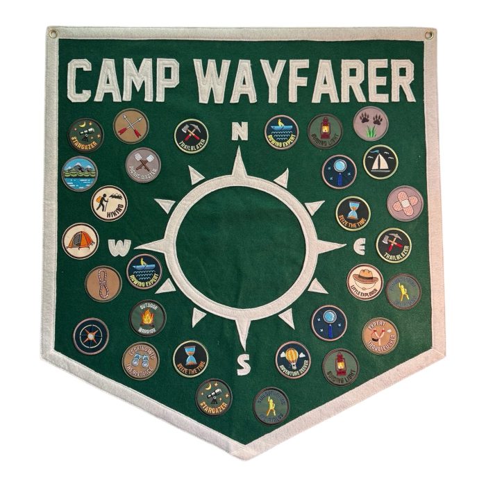 Green Camp Wayfarer compass felt pennant surrounded by colorful activity patches