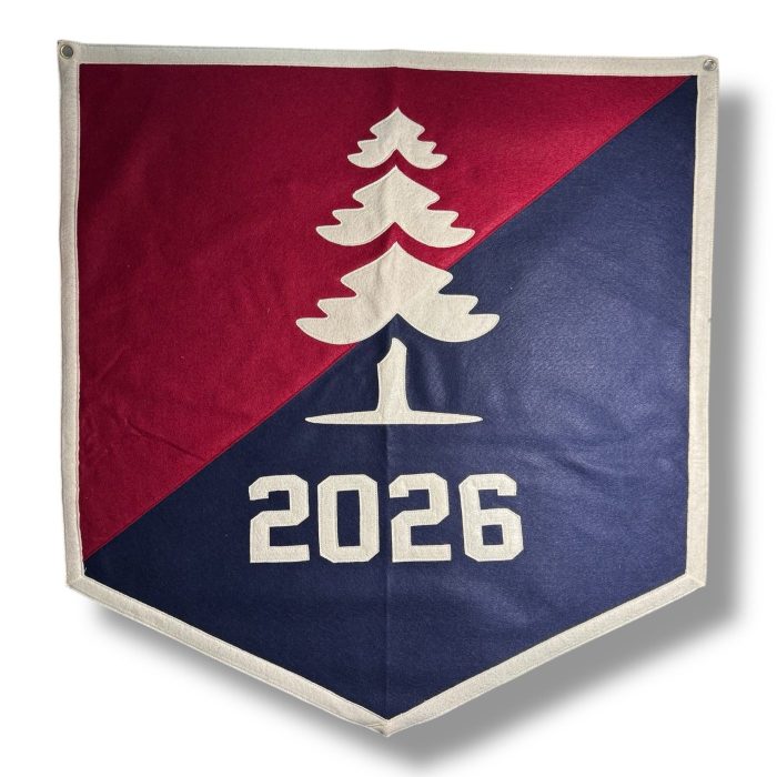 Crimson and navy split felt banner with a cream pine tree and the year 2026